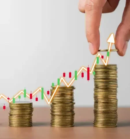 Growing stacks of coins with stock chart.